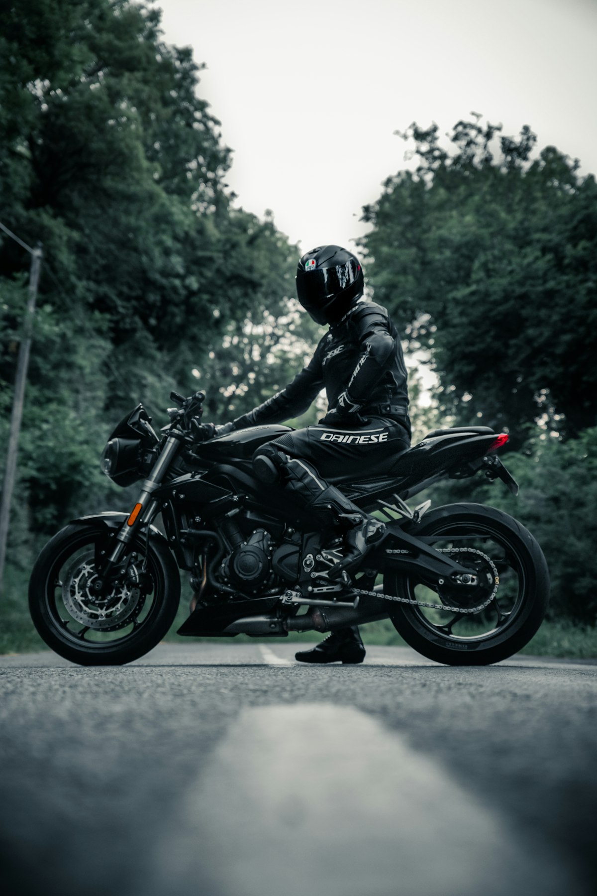 Motociclista con casco integral negro — línea de Cascos
